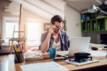 Young man working from home on his laptop