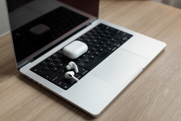 white wireless headphones on a laptop. 