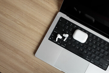 white wireless headphones on a laptop.