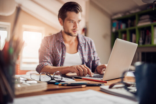 Young man working from home on his laptop