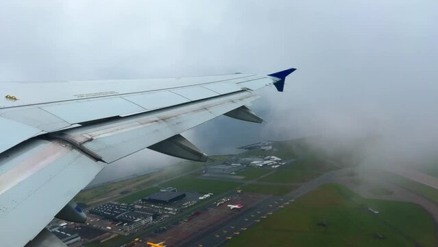 Passenger point of view of jet  Airbus A320 airplane wing at takeoff from Copenhagen airport on cloudy day