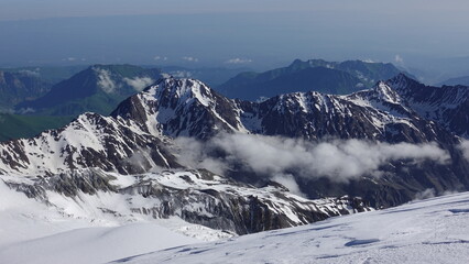 Fototapeta premium Mountains under snow in the clouds. The foothills of Kazbek