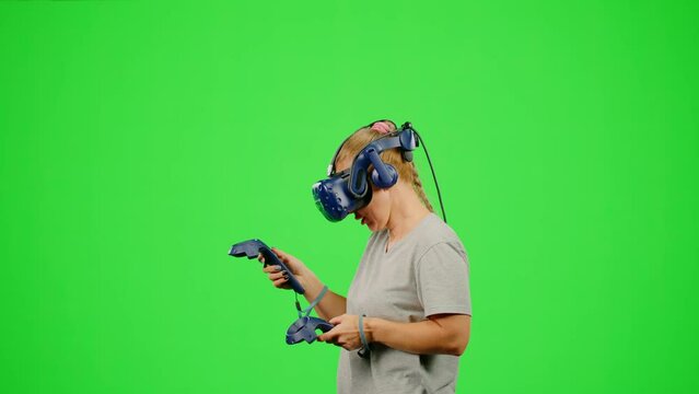 Woman in virtual reality paint imagination picture on chroma key green screen. The design artist VR headset drawing picture in virtual reality creativity game. Concept virtual reality art design game