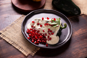 Chiles en Nogada, Typical dish from Mexico. Prepared with poblano chili stuffed with meat and fruits and covered with a walnut sauce. Named as the quintessential Mexican dish for national holidays.