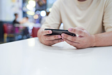 Man playing game on mobile phone. gamer boy playing video games holding Smartphone working mobile devices. cell telephone technology e-commerce concept