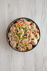 Homemade Summer Potato Salad in a Bowl, top view. Flat lay, overhead, from above.
