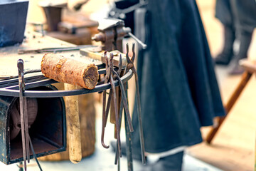 Different types of blacksmith mites hang next to the anvil