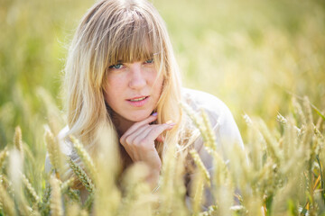 beautiful girl in a linen dress in a wheat field