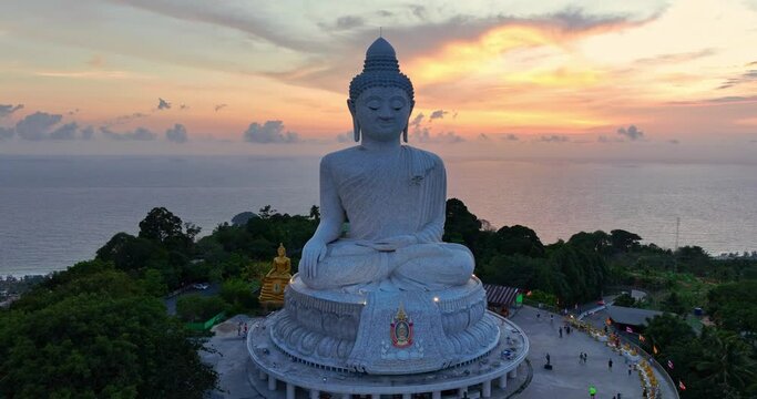  aerial view around Phuket big Buddha in beautiful sunset..360 degree view on Phuket big Buddha viewpoint..Video clips for travel and religious ideas..smooth cloud in stunning sky background.