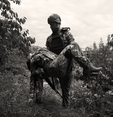 The commander carries a wounded soldier