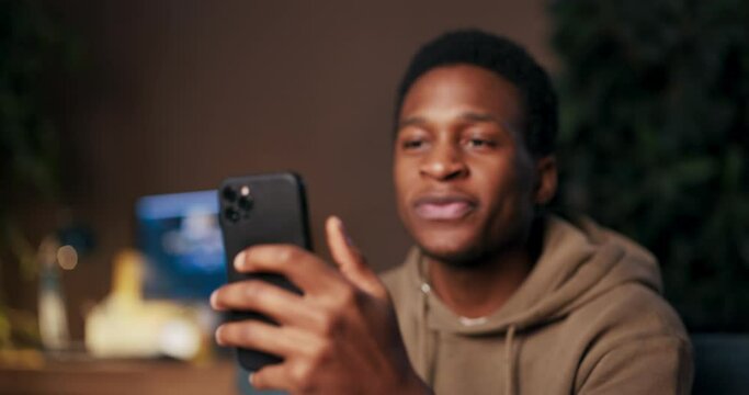 Motivational Speaker African American man delivering motivation through his cellphone, sharing uplifting content, offering encouragement, and spreading positivity with smiles and vibrant dances. - Powered by Adobe