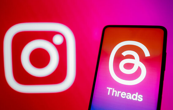 July 7, 2023, Brazil. In this photo illustration, the Threads logo is displayed on a smartphone screen. In the background, the logo of the social network Instagram.