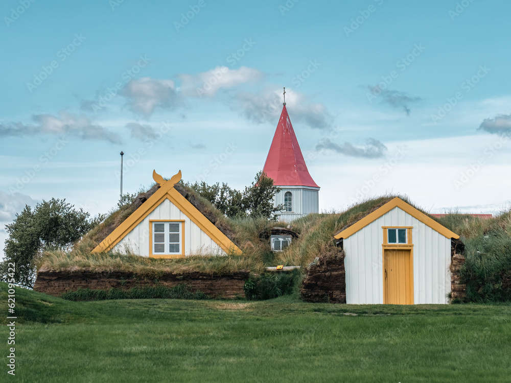 Wall mural traditional turf covered house in glaumbaer, northwestern iceland. agricultural fields with horses, 