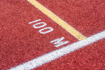 Close up of new red running track with 100 M text	