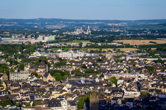 Sunset over the towns of Andernach in the foreground with the Raiffeisenbridge connecting Neuwied with Weissenthurm over the Rhine river and the former nuclear power plant visible in the distance.