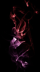 Obraz premium Coloured smoke. Black background. Colourful smoke images. Abstract photographs of smoke.
