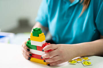 a small child plays with a constructor while building