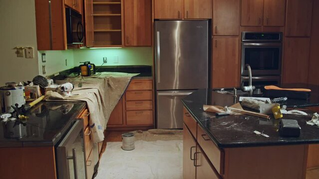 Wide angle plate shot of a messy kitchen that is under renovation