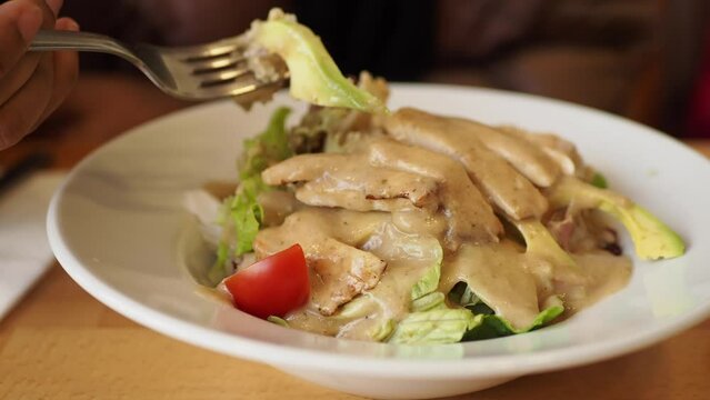 women eating vegetable salad with grilled chicken 