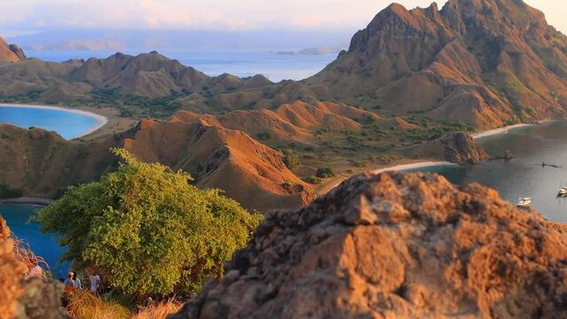 Padar island at sunrise in Komodo National Park in Indonesia, amazing Padar island coastline with cliffs in morning light, Indonesia vacation