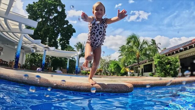 Little girl jumping into the water