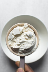 All purpose flour in a ceramic measuring cup, one cup of flour