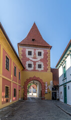 Fototapeta na wymiar Cesky Krumlov colorful medieval rectangular town gate with red roof