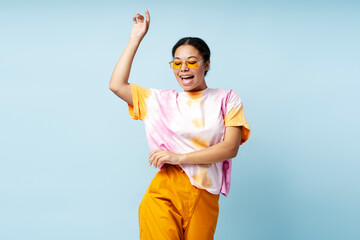 Happy African American woman dancing wearing trendy t shirt and eyeglasses