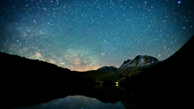 Amazing time-lapse of the night sky with the stars being reflected in a lake.
