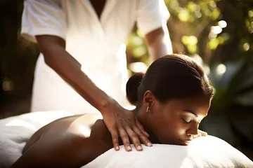 Keuken foto achterwand Massagesalon young beautiful woman enjoying a massage at an outdoor spa. vacation luxury hotel resort concept
