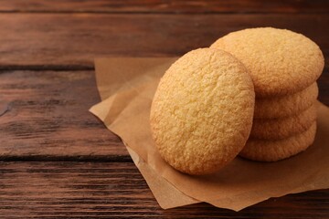 Delicious Danish butter cookies on wooden table, closeup. Space for text