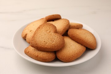 Heart shaped Danish butter cookies on white marble table, closeup