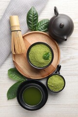 Flat lay composition with green matcha powder on white wooden table
