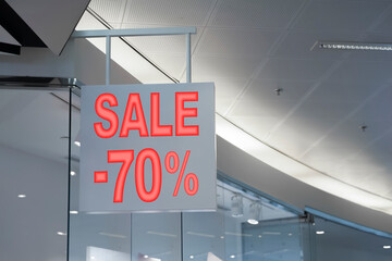 Sale sign near entrance in fashion store