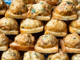 Street food Fried bread with minced pork spread for sale at a local market in Bangkok, Thailand.