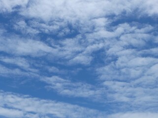 Obraz premium Bright blue sky against white clouds. Sky background. Cloud background.