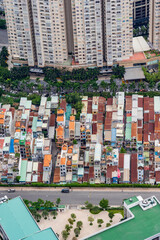 Aerial view of congested multi coloured houses between a highway and high rise apartments in Ho Chi...