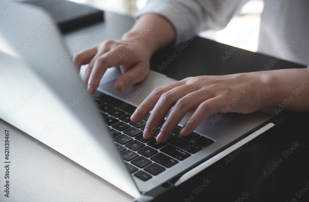 Wall mural Close up, woman hands typing on laptop computer keyboard, surfing the internet on office table, online, working, business and technology, internet network communication concept