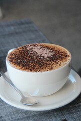 Delocious hot coffee with chocolate served on a cup.
