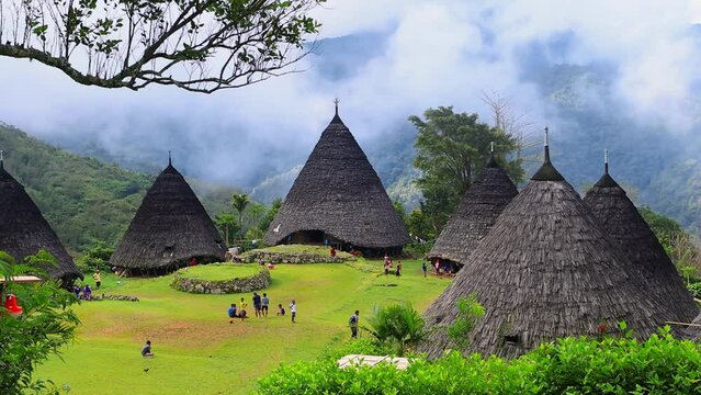 Wae Rebo village on Flores island in Indonesia, tourism in Indonesia, indigenous Indonesian tribes, mountain traditional village on foggy morning