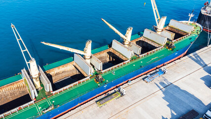 Huge container port with cargo ships and gantry cranes.
