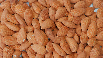 Close-up of organic, roasted almonds - a healthy and tasty snack. Concept of wholesome and nutritious food.