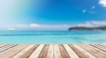Fototapeta premium Blurred sea background with wood resort deck floor foreground