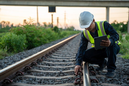 An engineer is sitting and inspecting the railway. Construction workers on the railway. Railway engineer. Infrastructure.