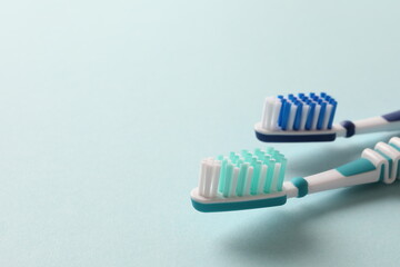 toothbrushes on a blue background, close-up, flat lay. Dentistry and healthcare concept