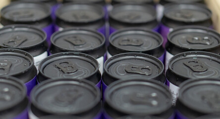 Background of black aluminium cans. Drink cans.