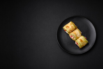 Delicious healthy vegetarian vegetable roll of zucchini, tomatoes, peppers and sauce