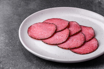 Delicious smoked salami sausage with salt, pepper, spices and herbs