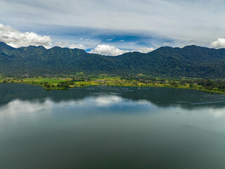 Farmland and rice fields on the Maninjau lake shore in the mountains. Sumatra, Indonesia.