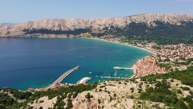 Krk island, Croatia: Aerial drone footage of the Baska vacations town in the Krk island in the Adriatic sea in northern Croatia. 